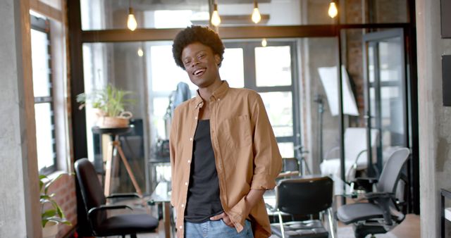 Confident Young Man Smiling in Modern Office Setting - Download Free Stock Images Pikwizard.com