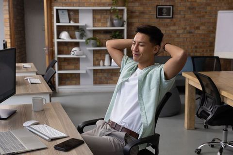 Relaxed Young Businessman in Modern Minimalist Office
