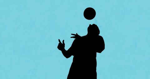 Silhouette of Football Player Juggling Ball on Blue Background - Download Free Stock Images Pikwizard.com
