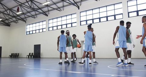 Young Diverse Basketball Team Practicing on Indoor Court