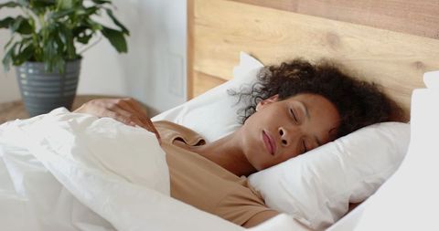 African American Woman Sleeping Peacefully in Bedroom