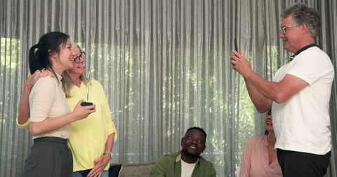 Celebratory moment in group therapy session with mixed group