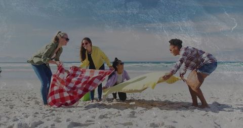 Four Diverse Women Preparing Picnic on Sunny Beach