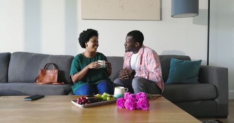Friends Sharing Coffee and Conversation in Comfortable Living Room