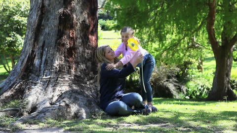 Joyful Moment Between Mother and Daughter in Sunny Park