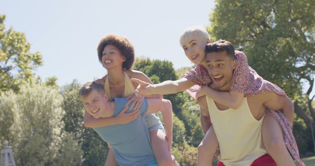 Friends Enjoying Piggyback Rides Outdoors in Sunny Park - Download Free Stock Images Pikwizard.com