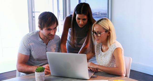 Young Professionals Collaborating on Laptop Project in Modern Office - Download Free Stock Images Pikwizard.com