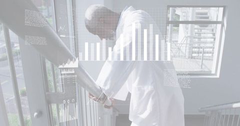 Mature medical professional leaning on stairwell railing with data visualization overlays