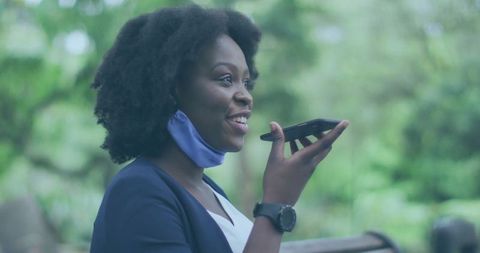 Smiling Executive in Park Using Smartphone