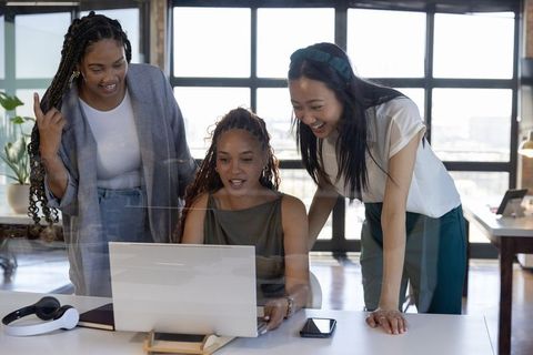 Diverse Team of Professional Women Collaborating in Modern Office Environment