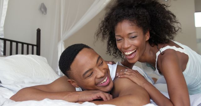 Happy African American Couple Relaxing on Bed Together - Download Free Stock Images Pikwizard.com