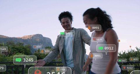 Young couple walking at mountain overlook at dusk with augmented reality overlays