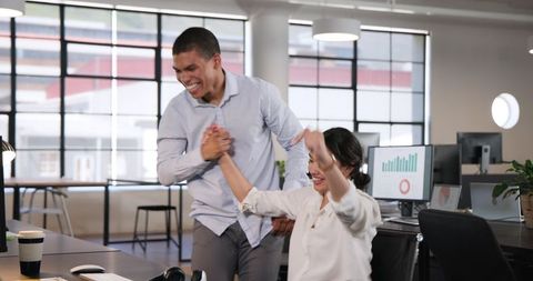 Excited Business Colleagues Celebrating Success in Modern Office