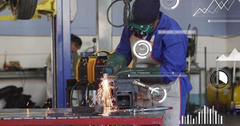 Welder wearing ppe grinding metal on vise with sparks and digital hud overlays