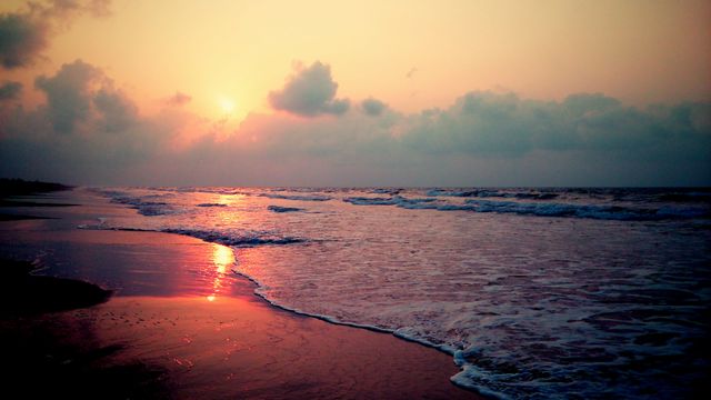 Serene Sunrise Over Calm Ocean Waves on Sandy Beach - Download Free Stock Photos Pikwizard.com