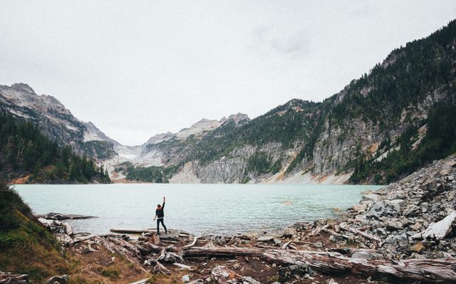 Solo Traveler Celebrating by Alpine Lake in Mountain Landscape - Download Free Stock Images Pikwizard.com