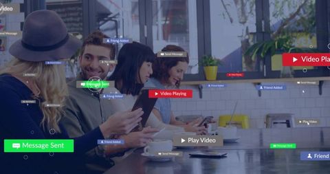 Group of Friends Socializing While Engaging with Interactive Digital Interfaces