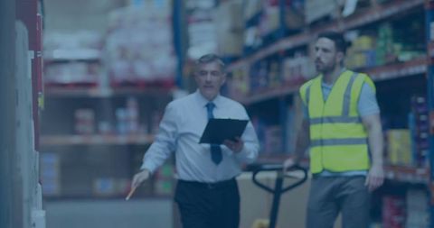 Warehouse manager and worker collaborating in logistics environment