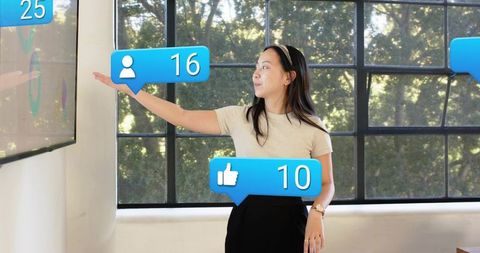 Presenter interacting with augmented social notifications near large window in office