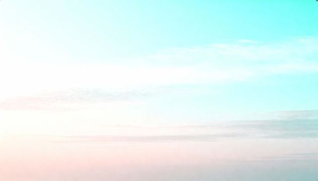 Expansive pastel sunrise sky with cyan-peach gradient and wispy cirrus clouds