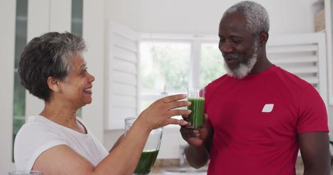 Mature Couple Enjoying Healthy Smoothie Together at Home