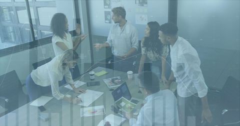 Diverse Business Team Analyzing Data in Modern Meeting