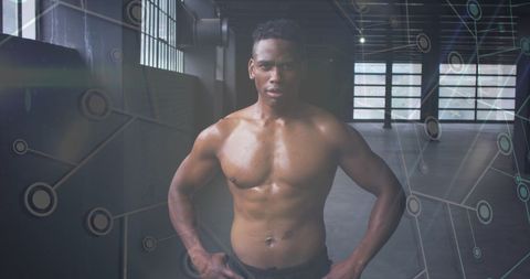 a muscular athlete stands confidently in an abandoned building. a digital network graphic overlays the scene, symbolizing the intersection of athletics and technology. this image conveys themes of strength, cutting-edge performance, and modern innovation. ideal for use in muscle fitness campaigns, digital health technology promotions, and articles exploring tech features in sports medicine and training.