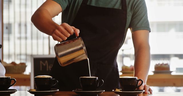 Barista Pouring Milk into Hot Coffee Cups at Counter - Download Free Stock Images Pikwizard.com