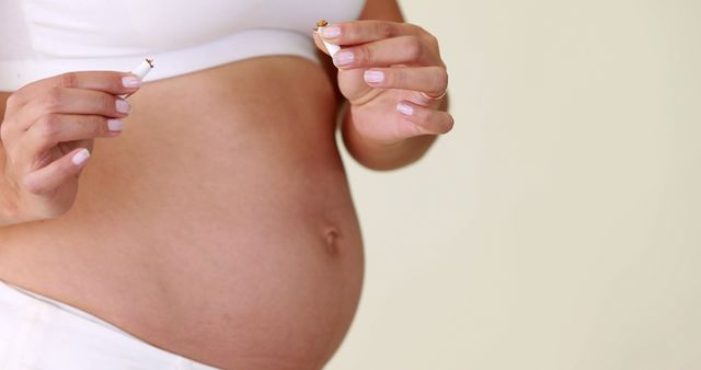 Pregnant Woman Breaking Cigarette for Healthy Lifestyle - Download Free Stock Images Pikwizard.com