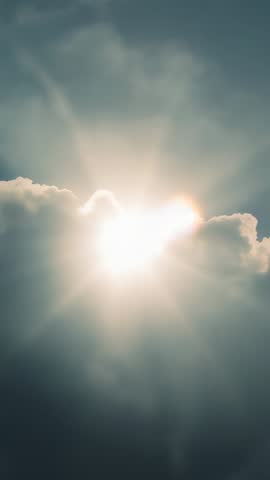 Sunburst Breaking Through Cumulus Cloud Vertical Video with Dramatic Rays and Lens Flare