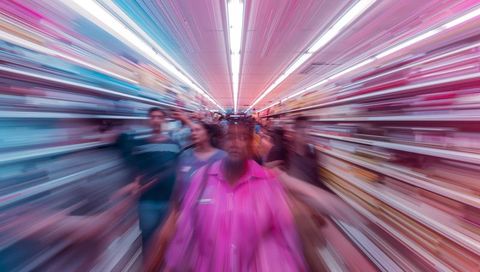 Walking crowd moving through supermarket aisle with radial motion blur and neon colors