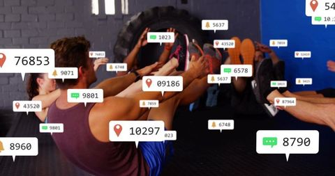 Holding v-sit core exercise in group fitness class with social media notification overlays
