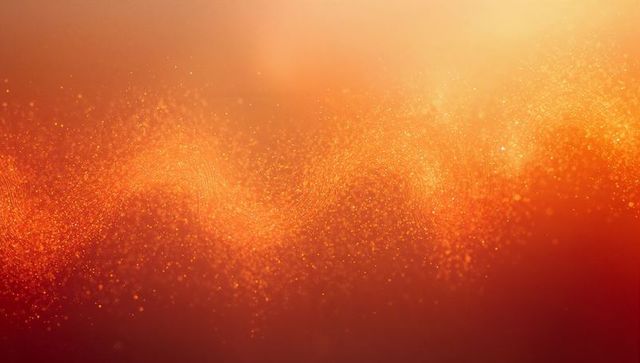 Golden particle wave drifting over warm gradient with glitter bokeh for festive abstract