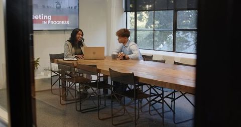 Diverse Colleagues Brainstorm Ideas in Modern Office Meeting