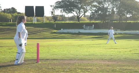 Women's Cricket Match on Bright Afternoon Sands Unity and Focus