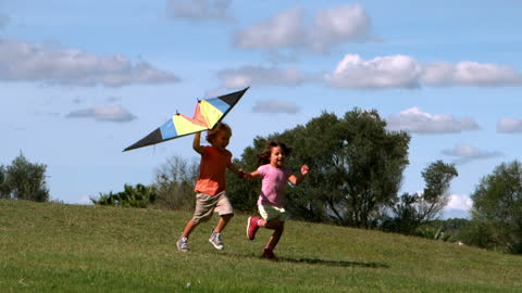 Joyful Kids Running with Colorful Kite in Park