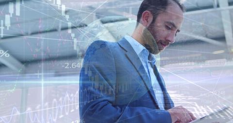 Businessman analyzing market data on tablet with stock charts and global finance overlays