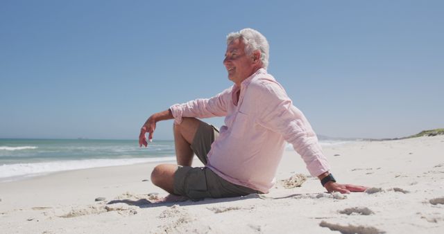 Senior Man Smiling and Relaxing on Sunny Beach - Download Free Stock Images Pikwizard.com