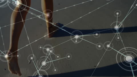 Digital Connections Overlaid on Woman Walking Beach at Sunset