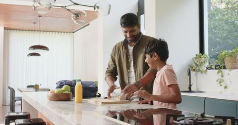 Father and Son Preparing Sandwiches in Modern Kitchen