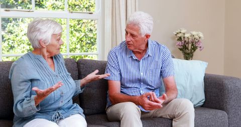 Senior Couple Having Disagreement on Living Room Couch - Download Free Stock Images Pikwizard.com
