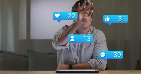 Man managing social media notifications on digital tablet