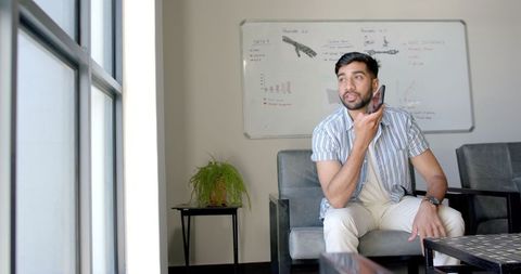 Professional Man Engaged in Phone Conversation at Office