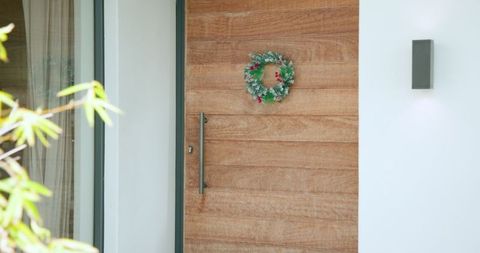 Wooden Front Door with Festive Wreath and Plant