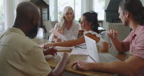 Family collaborating on wedding planning at home