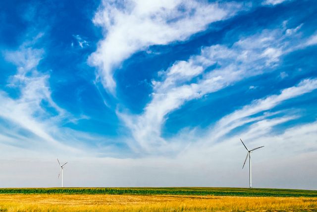 Two Wind Turbines in Open Field with Blue Sky and Cirrus Clouds - Download Free Stock Photos Pikwizard.com