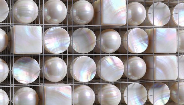 Iridescent pearl mosaic panel featuring lustrous spheres, discs and tiles in metal grid