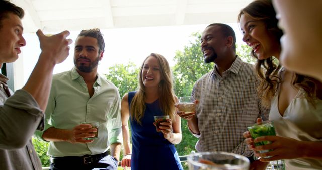 Group of Friends Enjoying Drinks and Laughter Outdoors - Download Free Stock Images Pikwizard.com