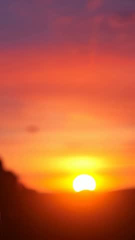 Clasping Hands Framing Rising Sun on Hill Ridge Vertical Video Conveying Partnership