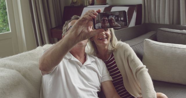 Happy Senior Couple Taking a Selfie on Couch at Home - Download Free Stock Images Pikwizard.com